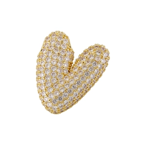 Macro shot of gold pendant V shape pavé set with sparkling cubic zirconia stones