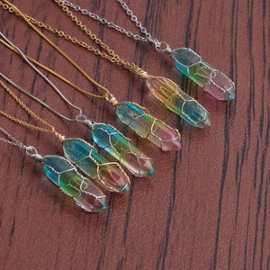 Macro shot of six wire-wrapped rainbow crystal pendants on gold and silver chains