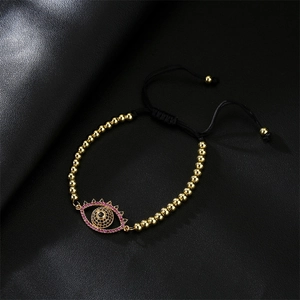 Close-up of adjustable evil eye bead bracelet with pink and black zircon charm