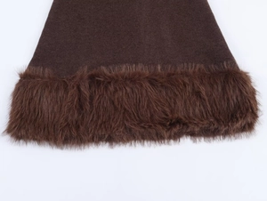 Close-up of deep brown velvet fabric with plush faux fur trim and detailed edge stitching