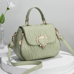 Quilted light green bucket bag with golden heart crown buckle and top handle