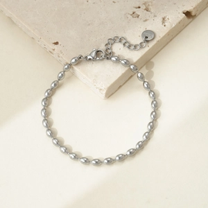 Detail of silver stainless steel oval bead bracelet with S.Steel engraved tag and clasp