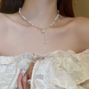 Elegant faux pearl choker necklace with heart pendant and delicate drop charm for women
