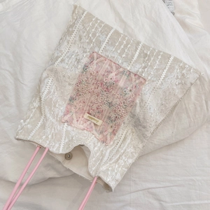 Detailed view of French vintage velvet tote bag with lace pocket and pink handle