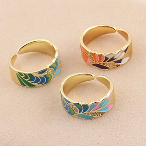 Three gold-plated adjustable rings with colorful enamel feathers and micro-set zircons