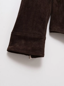 Detail view of dark brown faux suede jacket featuring a premium silver metal zipper