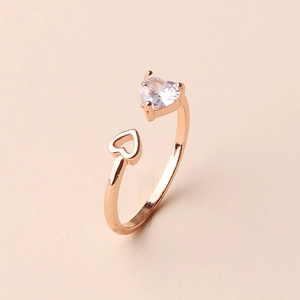Detailed shot of rose gold open ring with heart-shaped zircon and hollow heart design