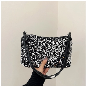 Close-up of black sequin baguette bag with silver accents and durable zipper detail