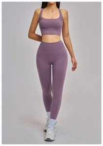 Detail of purple high-waisted seamless yoga pants and sports bra with ribbed texture