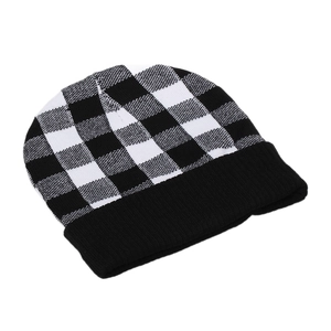 Classic black and white checkered knit beanie with thick black ribbed cuff for winter warmth