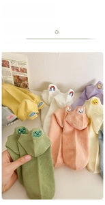 Detail of colorful cotton socks featuring cute cartoon animal embroidery and ribbed texture