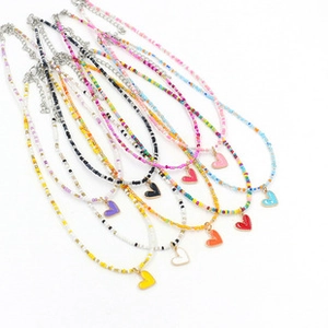 Detail of colorful seed bead necklaces with heart pendants and adjustable lobster clasp