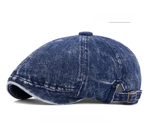 Detail of dark blue washed denim beret featuring a vintage bronze adjustable buckle