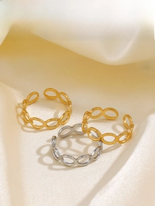 Detail of adjustable geometric oval hollow rings in gold and silver finish on silk