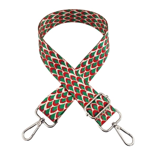 Detail of red and green fish scale pattern strap with silver metal hooks and adjuster