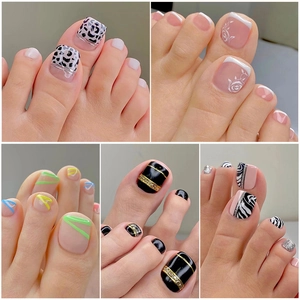 Collection of various false toe nail designs including leopard print and geometric patterns