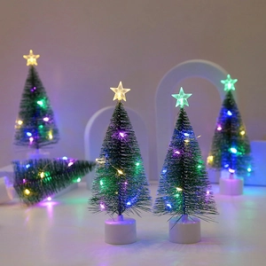 Set of four mini LED Christmas trees with star toppers and green pine needles decoration