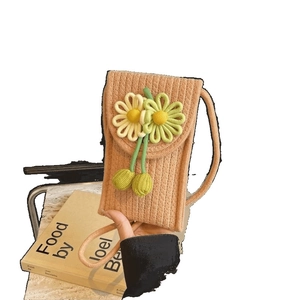 Handmade woven phone bag with yellow floral accents for beach vacations and casual wear