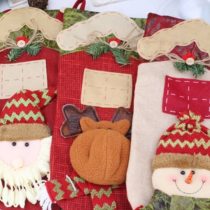 Detailed view of 3D Santa, Elk and Snowman motifs on festive Christmas stockings