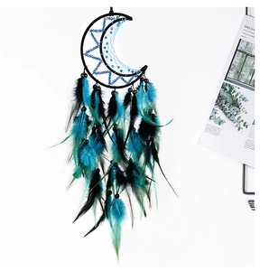 Detail of moon-shaped dreamcatcher with blue mesh, black feathers and decorative beads