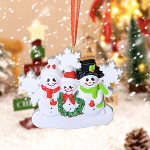 Detailed view of resin snowman family ornament with blank name bar and red hanging ribbon