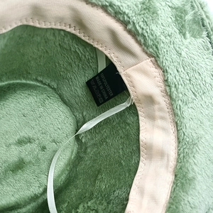 Detail view of the soft faux rabbit fur lining and interior wash label of the fedora hat