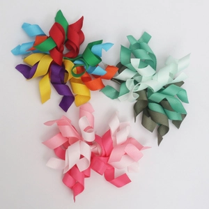 Detailed view of handmade grosgrain ribbon spiral hair clips in various bright colors