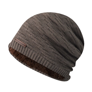 Close-up of deep brown winter knit hat with soft fleece lining and leather logo tag