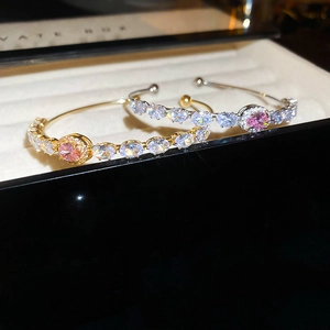 Macro shot of French luxury open cuff bracelets with pink oval stones and white zircons
