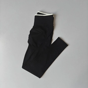 Flat lay of seamless yoga pants with high waist and white contrast trim detailing