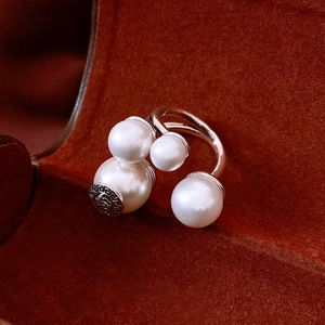 Macro view of vintage silver ring with pearls on red velvet gift jewelry box