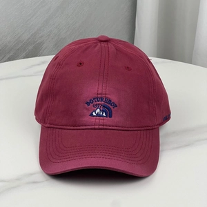Casquette de baseball en coton bordeaux avec broderie bleue sur marbre blanc
