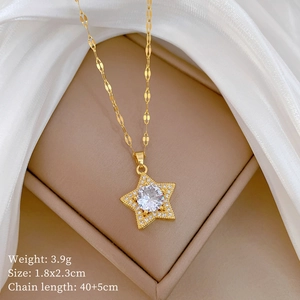 Macro view of gold star pendant with large white zircon on elegant silk background