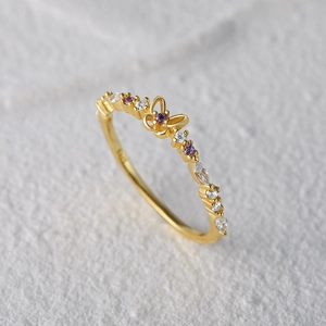 Macro shot of S925 silver gold butterfly ring with purple gemstones and zircons