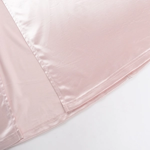 Detailed close-up showing split hem stitching and glossy pink satin fabric texture