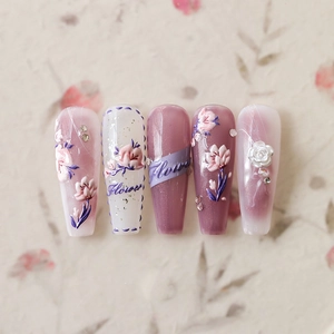5D floral press-on nails with 3D embossed flowers, pearls and purple ribbon design