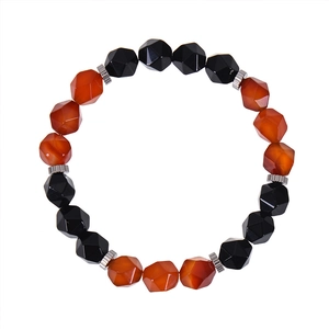 Detailed view of faceted red agate and black obsidian beads with silver metal spacers