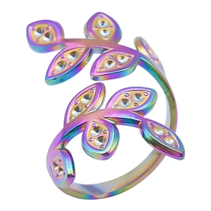 Macro detail of rainbow stainless steel leaf ring with embedded crystal and open band