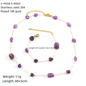 Detail of 18k gold plated stainless steel jewelry set with natural stones and pearls