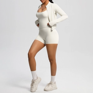 Three-piece yoga set with zip jacket, sports bra, and high-waist shorts in cream white
