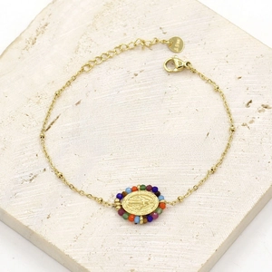 Detail of colorful natural stones and Virgin Mary charm on a golden stainless steel chain