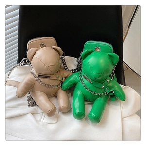 Detail of cute bear-shaped PU leather crossbody bag with silver chain and metal plate