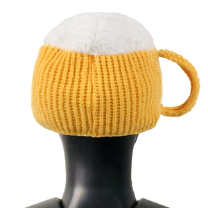 Close-up of a 3D beer mug knitted hat featuring yellow body and white foam textures