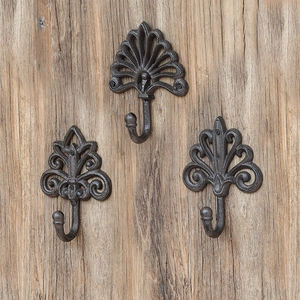 European vintage cast iron decorative wall hooks mounted on rustic wooden board