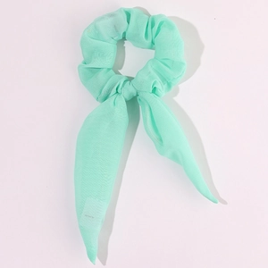 Detail shot of mint green LED hair scrunchie with bow made of sheer chiffon fabric