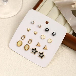 316L stainless steel earring set with pearls, floral designs, and crystals on a card