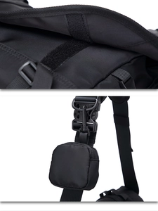 Detail view of black functional crossbody bag with tactical velcro and strap attachment system