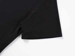 Detailed close-up of premium black knitted fabric showing high-quality stitching and texture