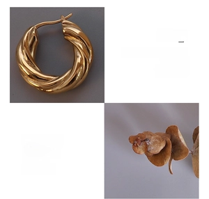 Macro shot of 18K gold plated titanium steel twisted hoop earrings with textured finish