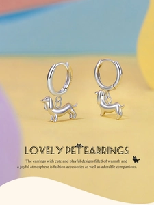 Detail of lovely S925 sterling silver dachshund dog earrings on geometric background